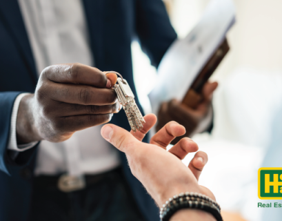 real estate agent handing keys to another person