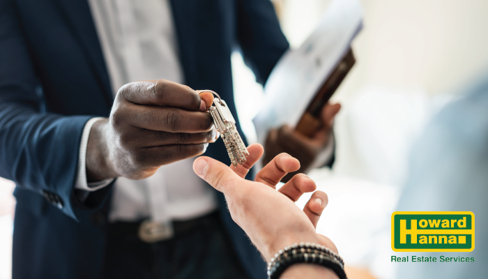 real estate agent handing keys to another person