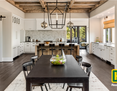 a dining room with furniture next to a kitchen and bar