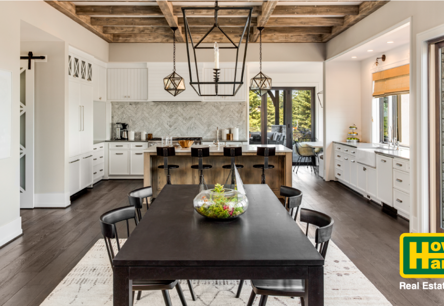 a dining room with furniture next to a kitchen and bar